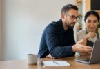 IT consultant and small business owner reviewing systems on a laptop