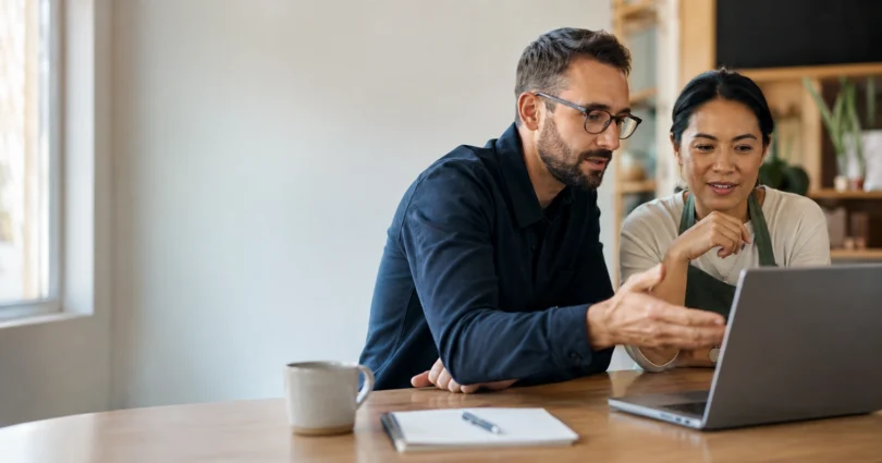 IT consultant and small business owner reviewing systems on a laptop